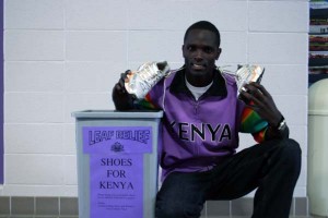 Shoes for Kenya Sam Chege, a senior, shows off his shoes next to the collection bin located in the lobby of the Recreation-Fitness Center. Photo by Brandon Long
