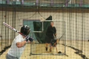 baseballpractice-2 The G.C. Baseball team often practices indoors, using netted batting cages. Photo by Trisha Handrich.