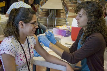 GHS NURSING (EMily Miller) Michelle Kauffman, right, a senior nursing major, was one of several nursing students who administered H1N1 vaccines at Goshen High School on Friday. Photo by Emily Miller.