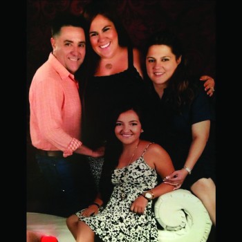 Enrique Fonseca, stands with his wife, Elizabeth and his two daughters: Frances, a sophomore at Goshen College, and Ashley.