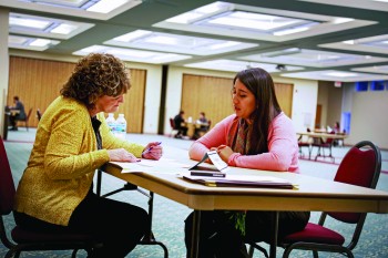 Sara Garcia, senior, goes over her resume with an advisor during last semester's Super Tuesday event