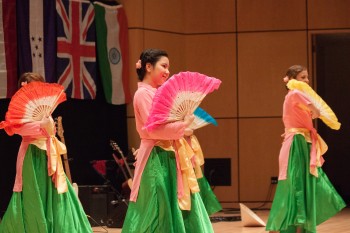 Chau Bui and Sam Weaver, seniors, performed a traditional Vietnamese dance at the International Student Coffeehouse.