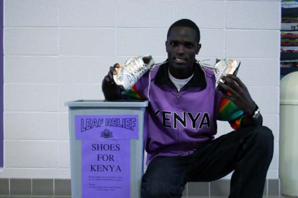 Sam Chege with shoe collection bin