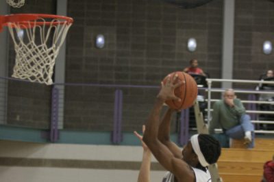 McCollum shoots a basketball