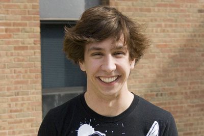 Jacob Schlabach smiles for the camera. He is wearing a T-shirt with a cartoon version of Abraham Lincoln holding a sword