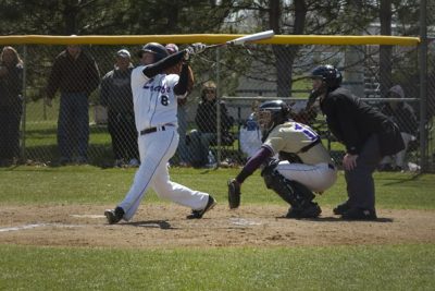 Baseball player hits ball