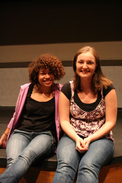 Gina Stutzman and Grace Eidmann sit on the Umble Center stage and pose for a picture