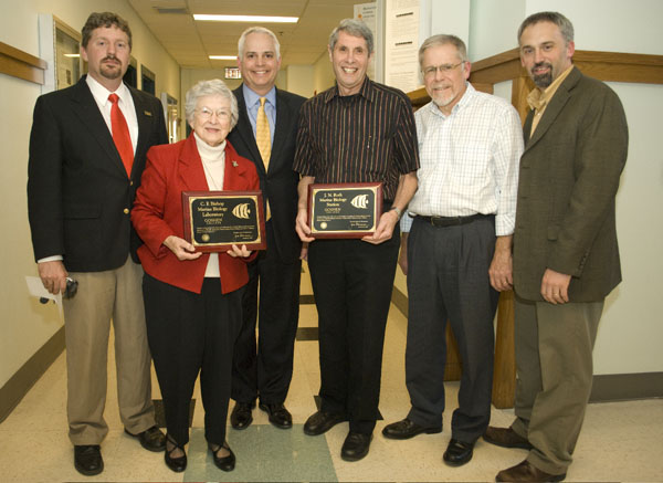 The Marine Biology facility in the Florida Keys was named for two influential professors. Jonathan Roth (center) was a available to accept his plaque, but Bishop's was accepted by his family, as he is deceased. Photo by Jodi Beyeler.