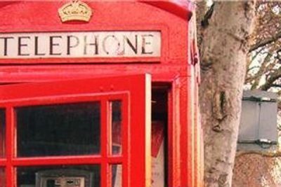 Kate Walker poses for a picture in a British telephone box