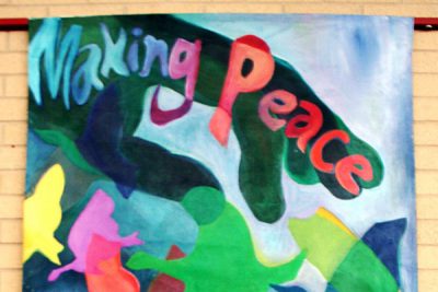 Andrea Kraybill's colorful banner reads "Making Peace with God"