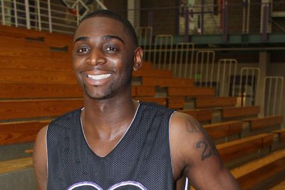 Daniel Butler holds basketball in gym