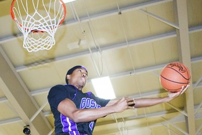 Basketball player goes up for dunk