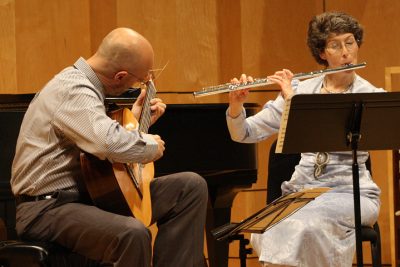 Matthias Stegmann plays guitar and Rebecca Hovan plays flute in Rieth Recital Hall