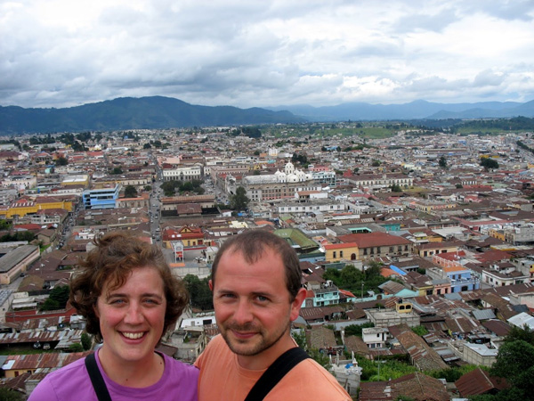 Jodi Beyeler and a man pose for a picture with the city of Quetzaltenango as their backdrop