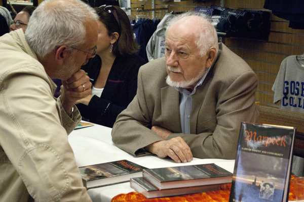 William Klassen converses with a reader at a book signing event