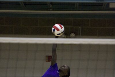 volleyball player spikes ball in game