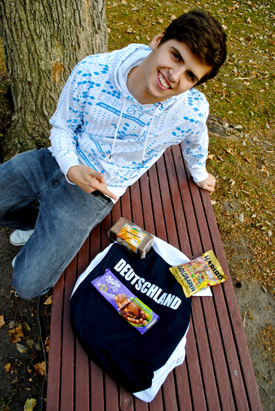 Jan Zawadzki sits on a bench next to a black T-shirt reading "Deutschland" and a bag of Haribo gummy bears