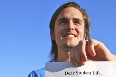 Ruth holds up a letter to student life