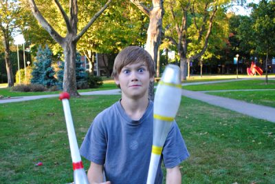 10 year-old Simon Graber-Miller juggles on the Goshen College campus