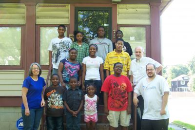Gary and Gwen Miller with participants in their Urban Faith Works organization in front of the newly renovated center.