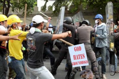 Photo of a groundhog holding a sign reading "God Hates Groundhogs" at a protest