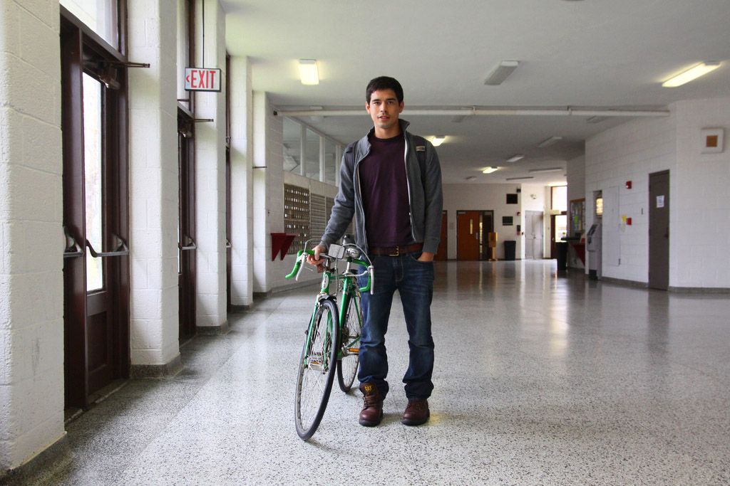 Reuben Maldonado Nafziger walks his bike down a hallway