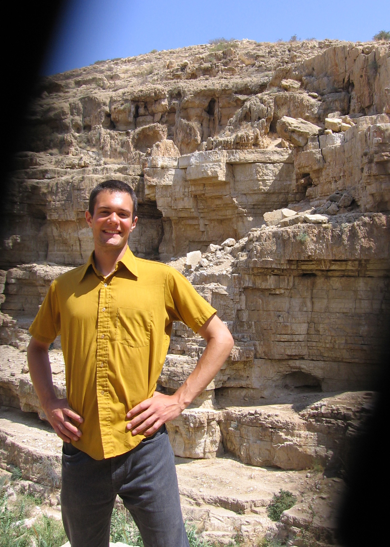 Levi Smucker poses for a picture in front of a Palestinian rockface