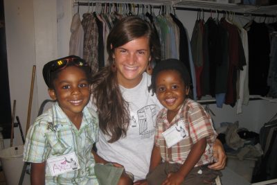 Mara Weaver poses for a picture with two children