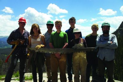 Students with giant saw in Rocky Mountains