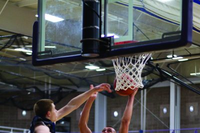 basketball player goes up to basket