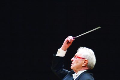 Maestro Vance George conducting with a baton