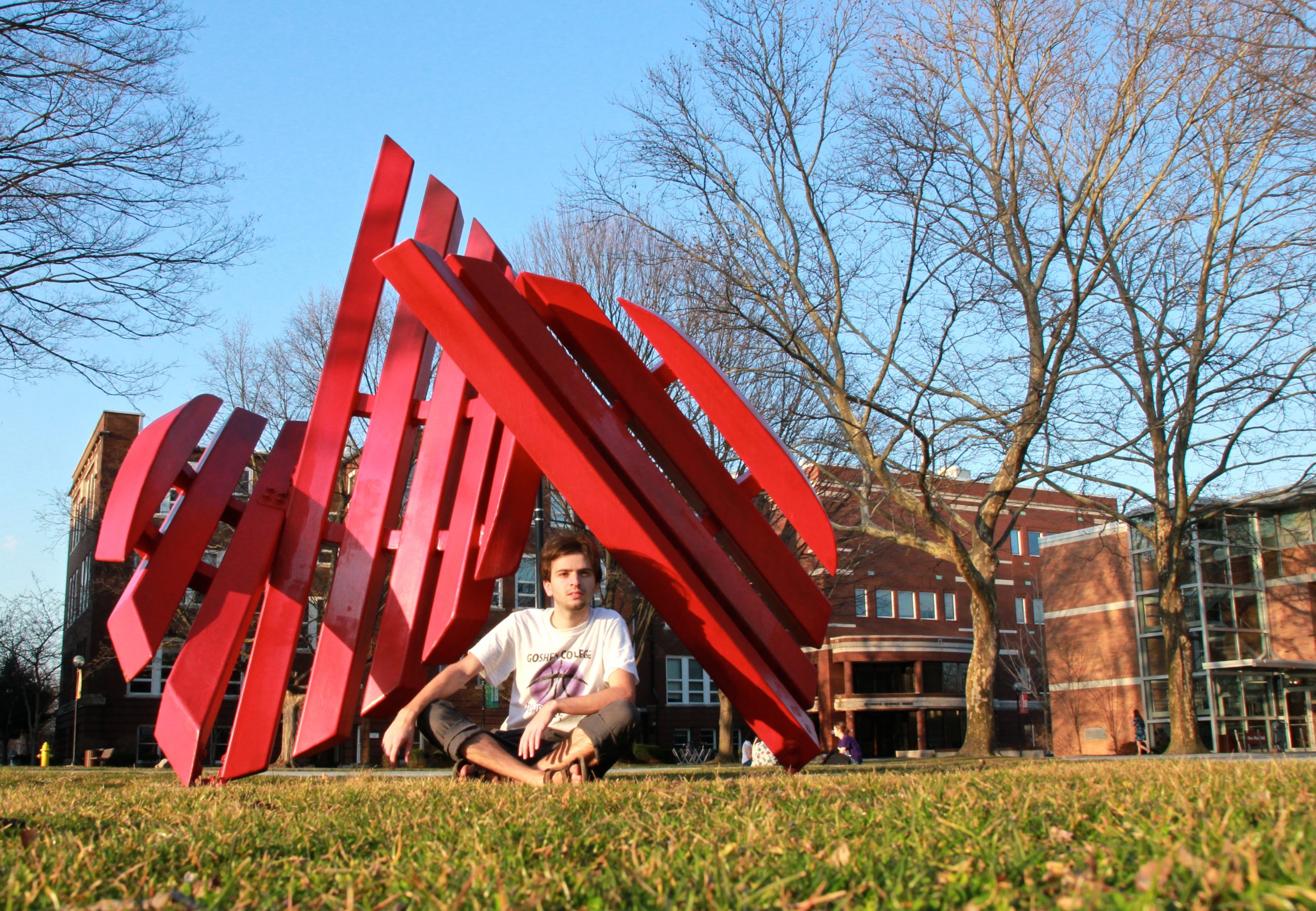 Daniel Penner sits under the Broken Shield sculpture