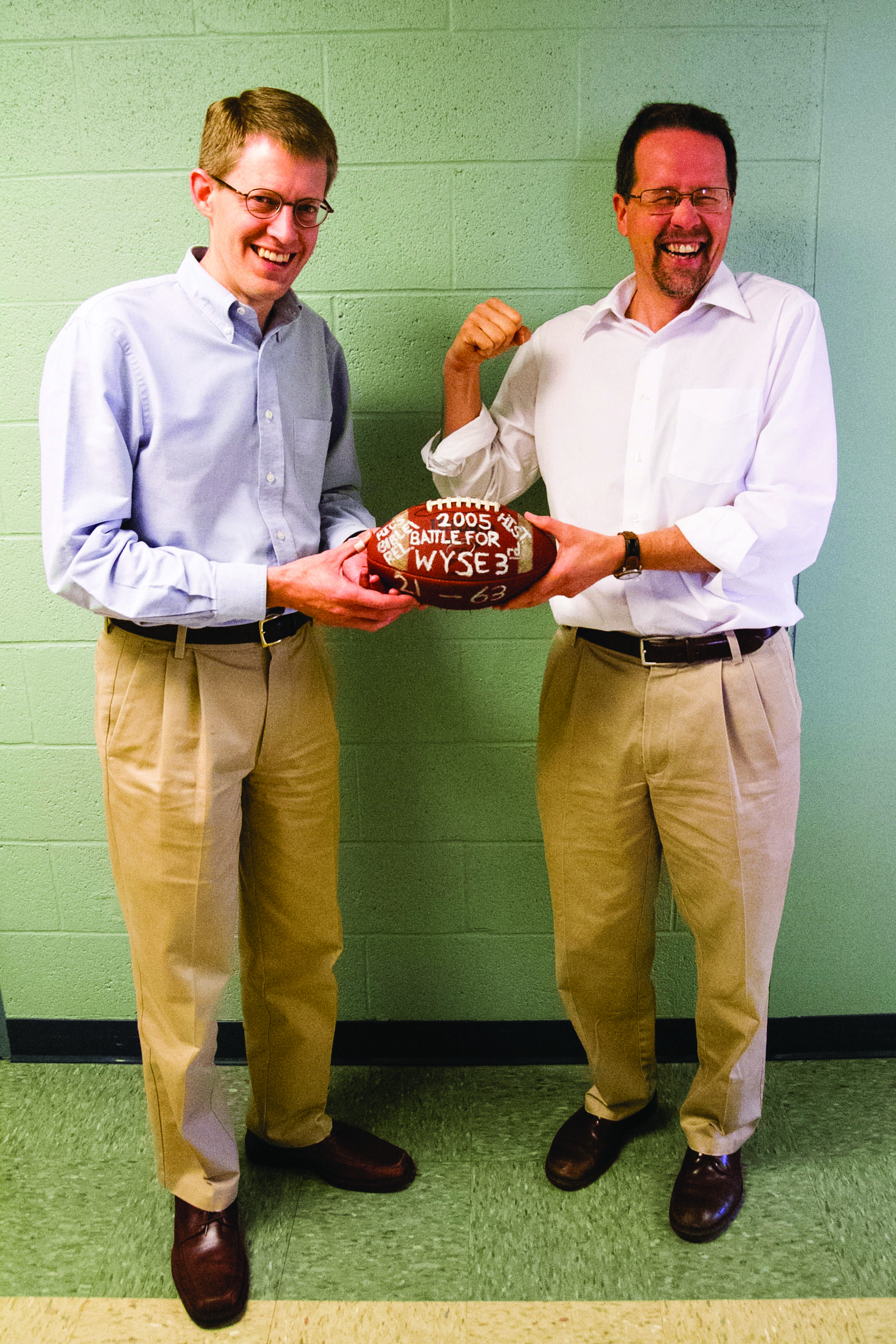 Professors Steven Nolt and John Roth hold the famed "Battle for Wyse 3" football