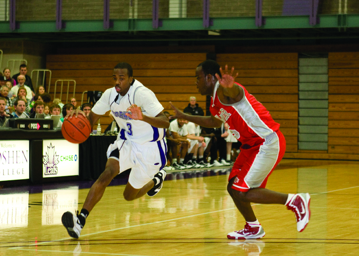 Wearing his Goshen College jersey, Errick McCollum dribbles the ball down the court in the RFC and keeps a player from an opposing team away