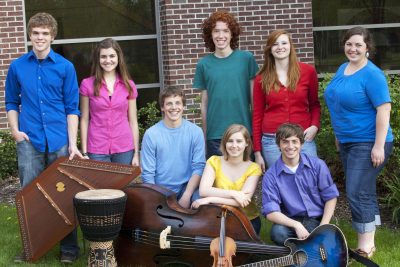 Members of Parables pose for a picture with their instruments outside the Music Center