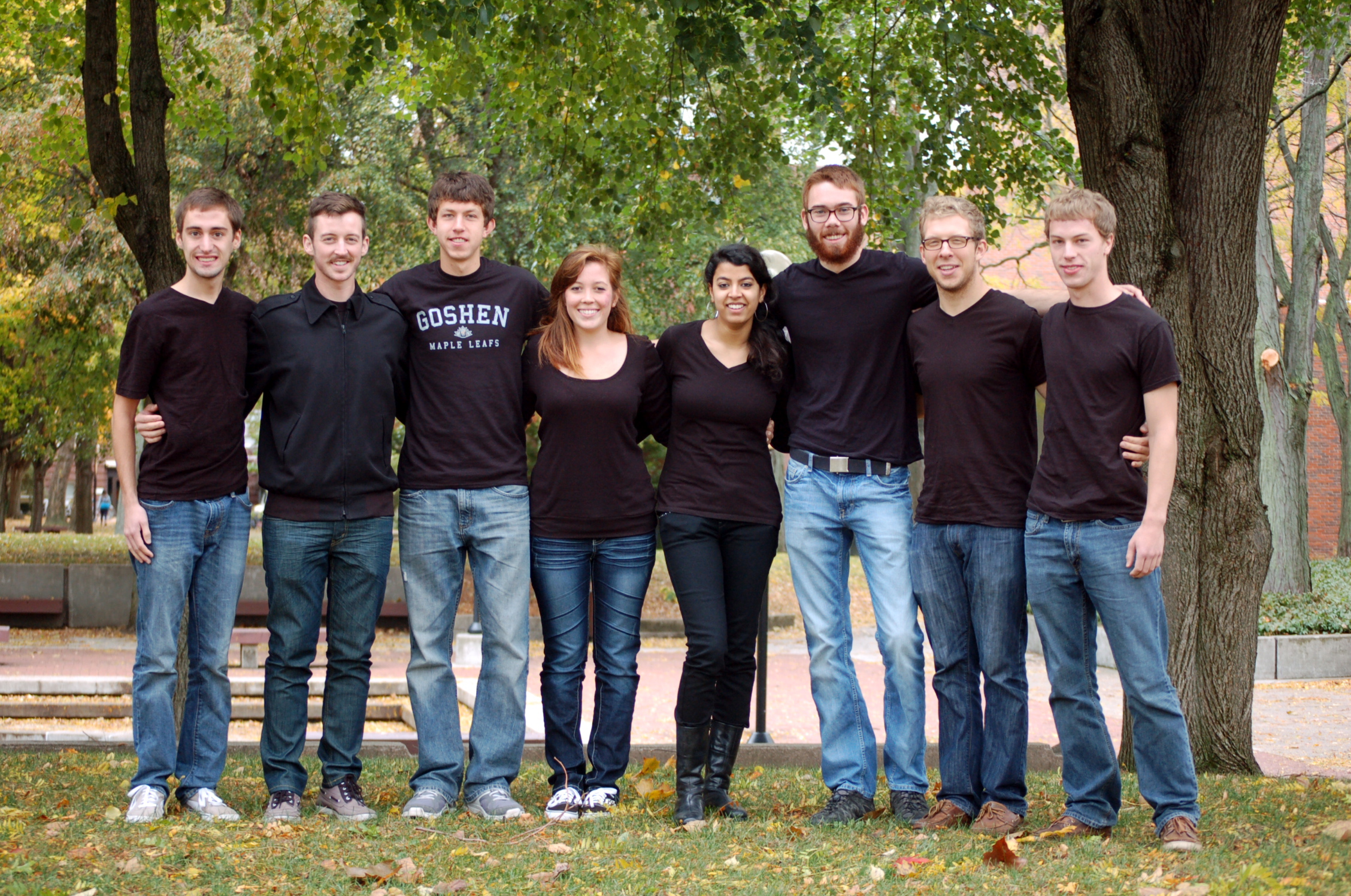 The eight members of Student Senate group together for an outdoors picture