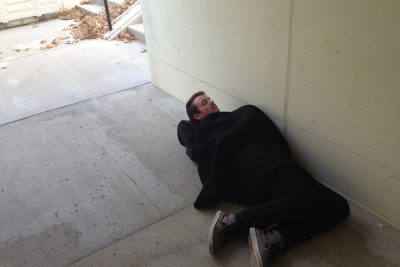 Student laying in underpass
