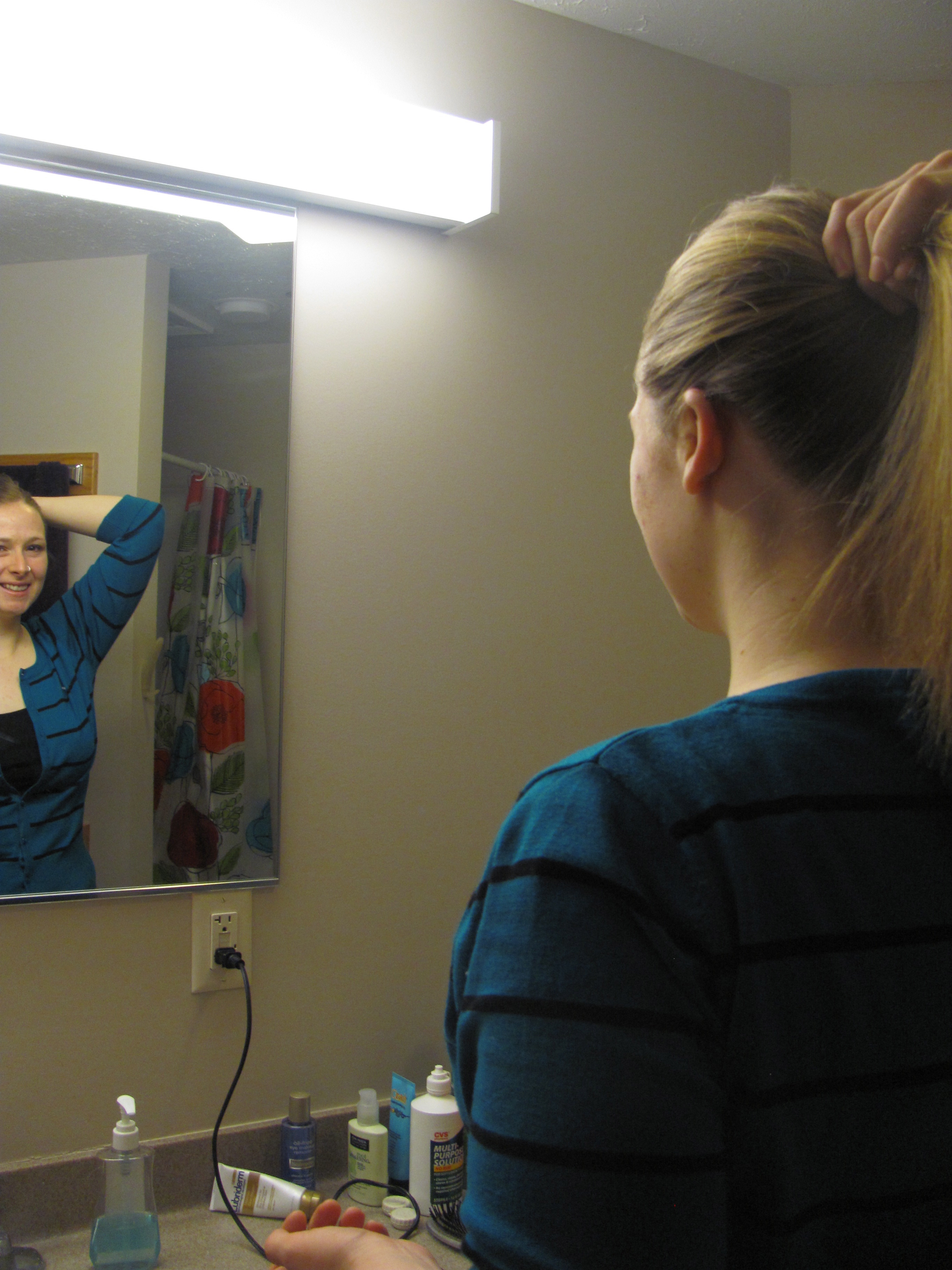 Erin Brenneman looks at herself in the mirror