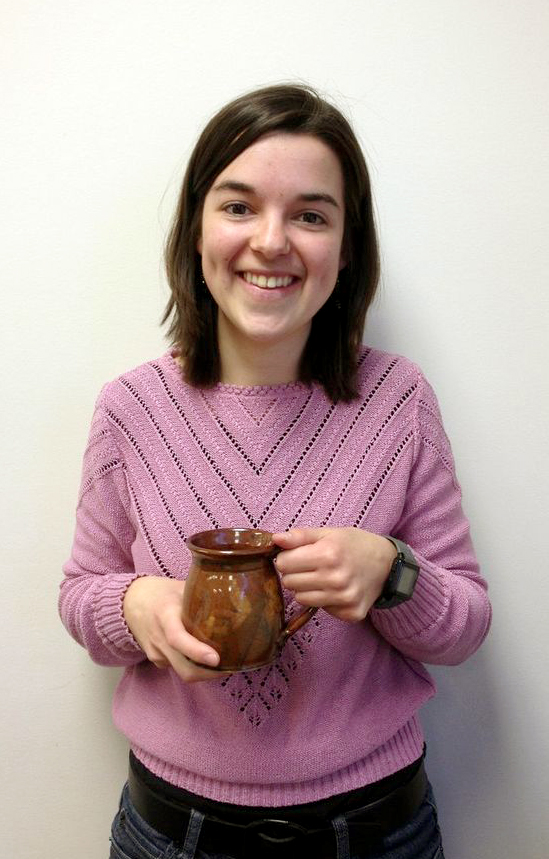 Photo of Becca Yoder smiling and holding a mug