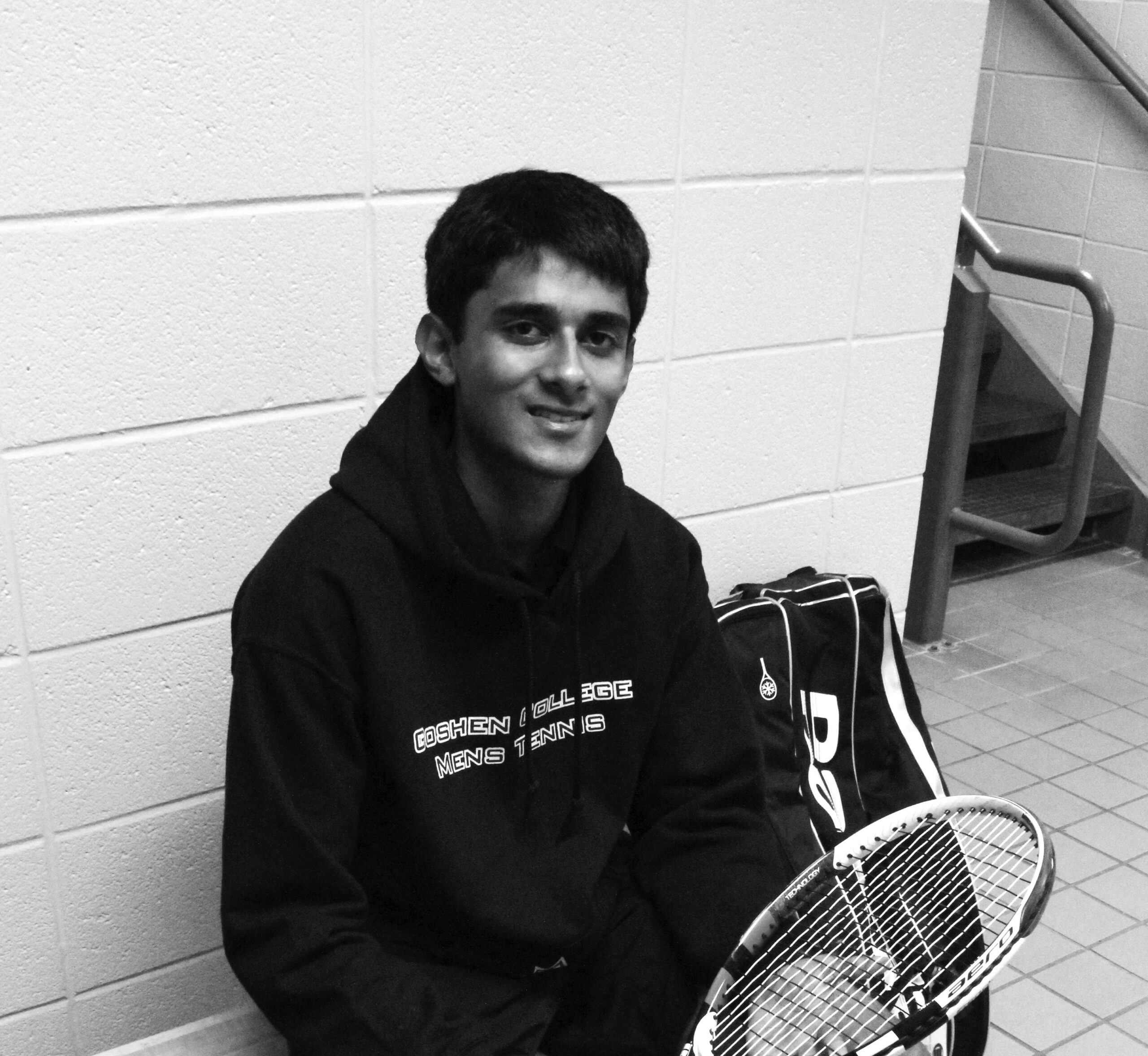 Siddratha Ratnutunga sits on the floor of the RFC with his tennis racket
