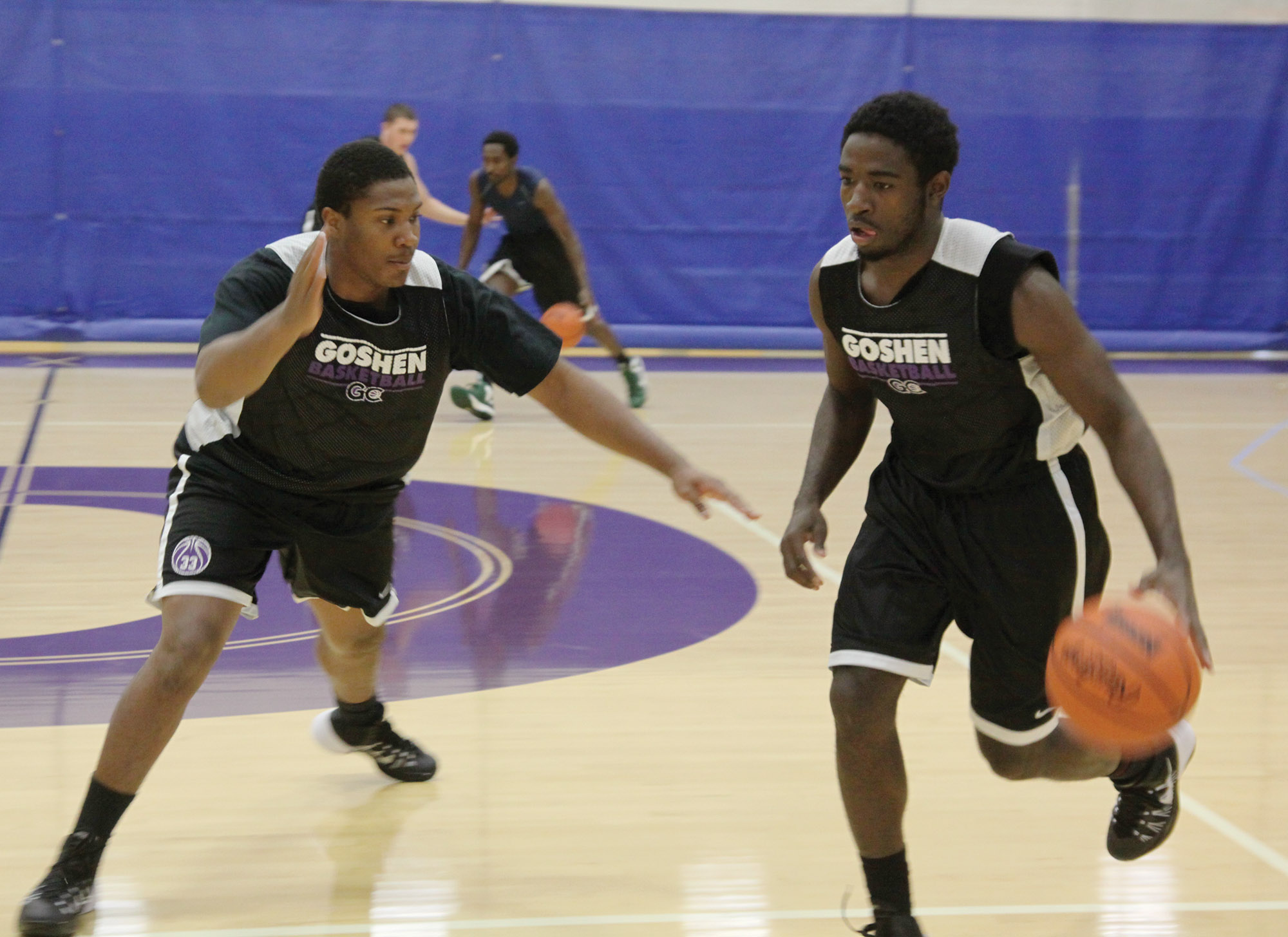 Tre Boyd and Terry Cook Jr. practice basketball in the RFC gym