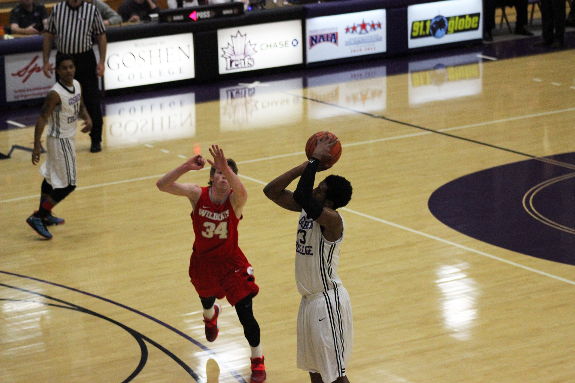 basketball player shoots the ball