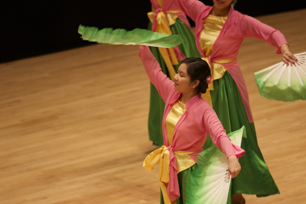 Chau Bui performs a Vietnamese dance using fans. 