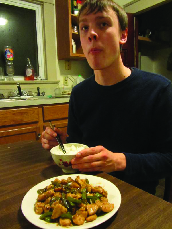 Sam Smucker eats a homemade Chinese dish in his home