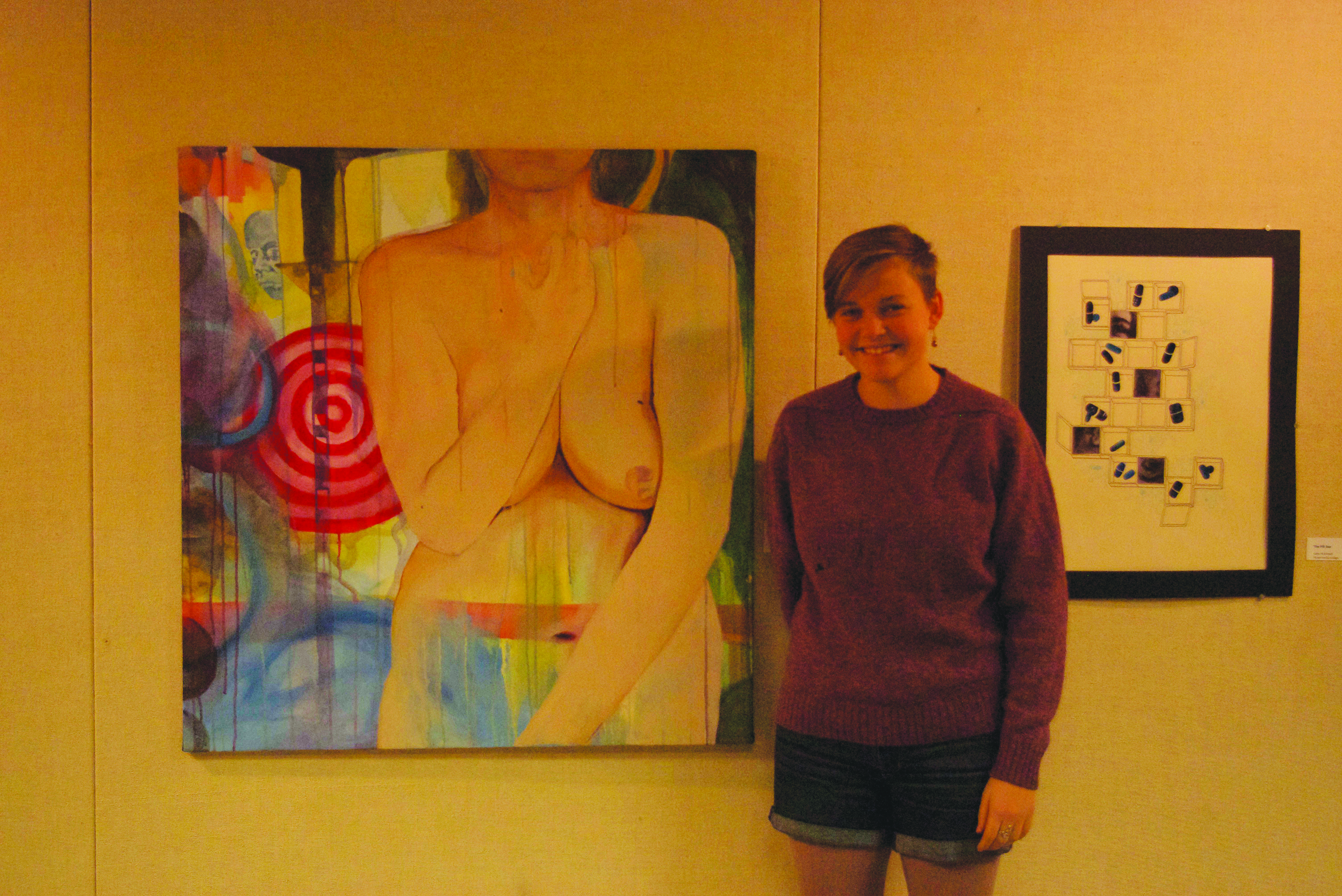 Ardys Woodward poses with her painting entitled "Tolerance and the Other"