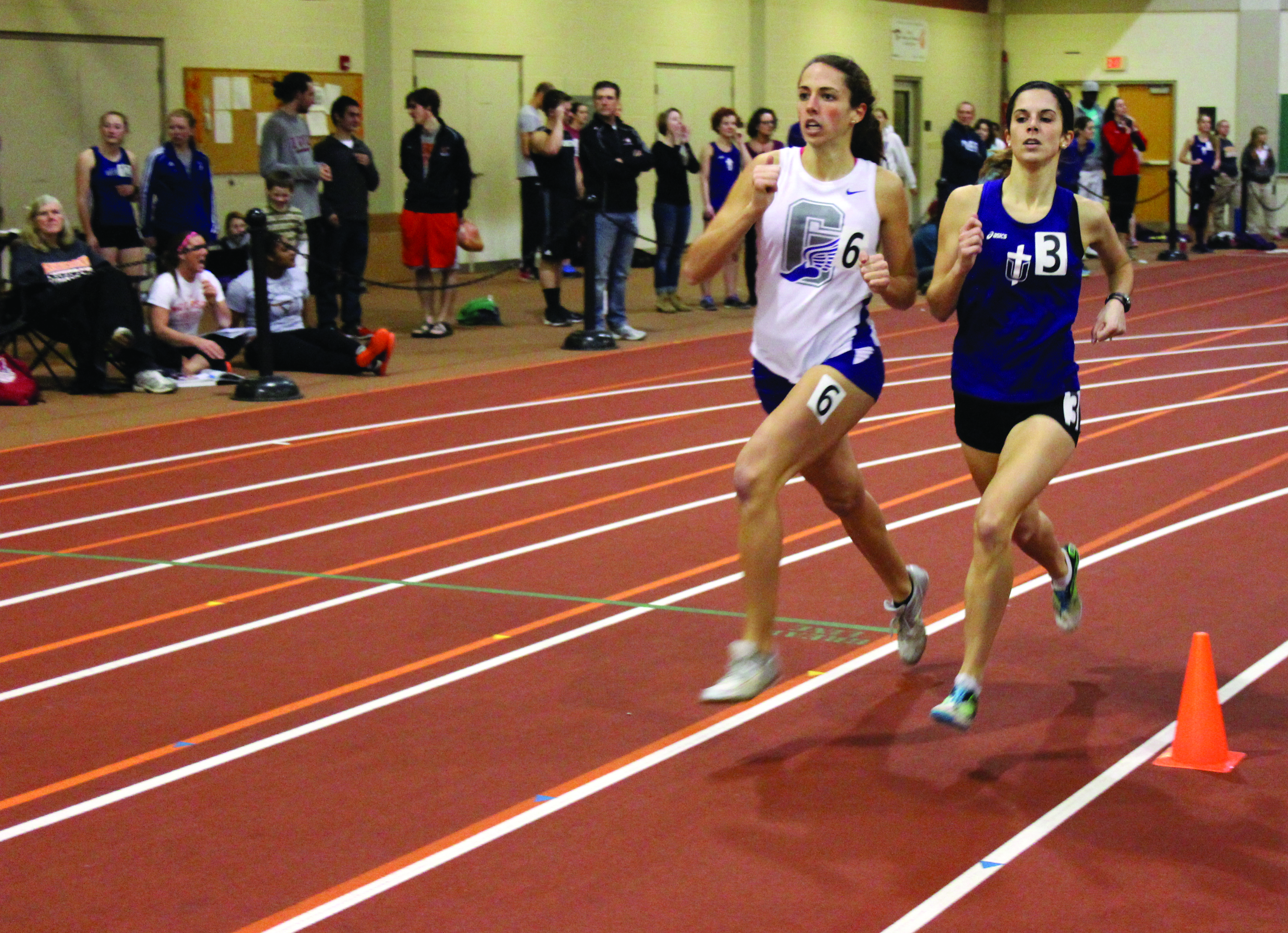 Mollie Nebel passes an opposing runner during a race at an indoor track meet