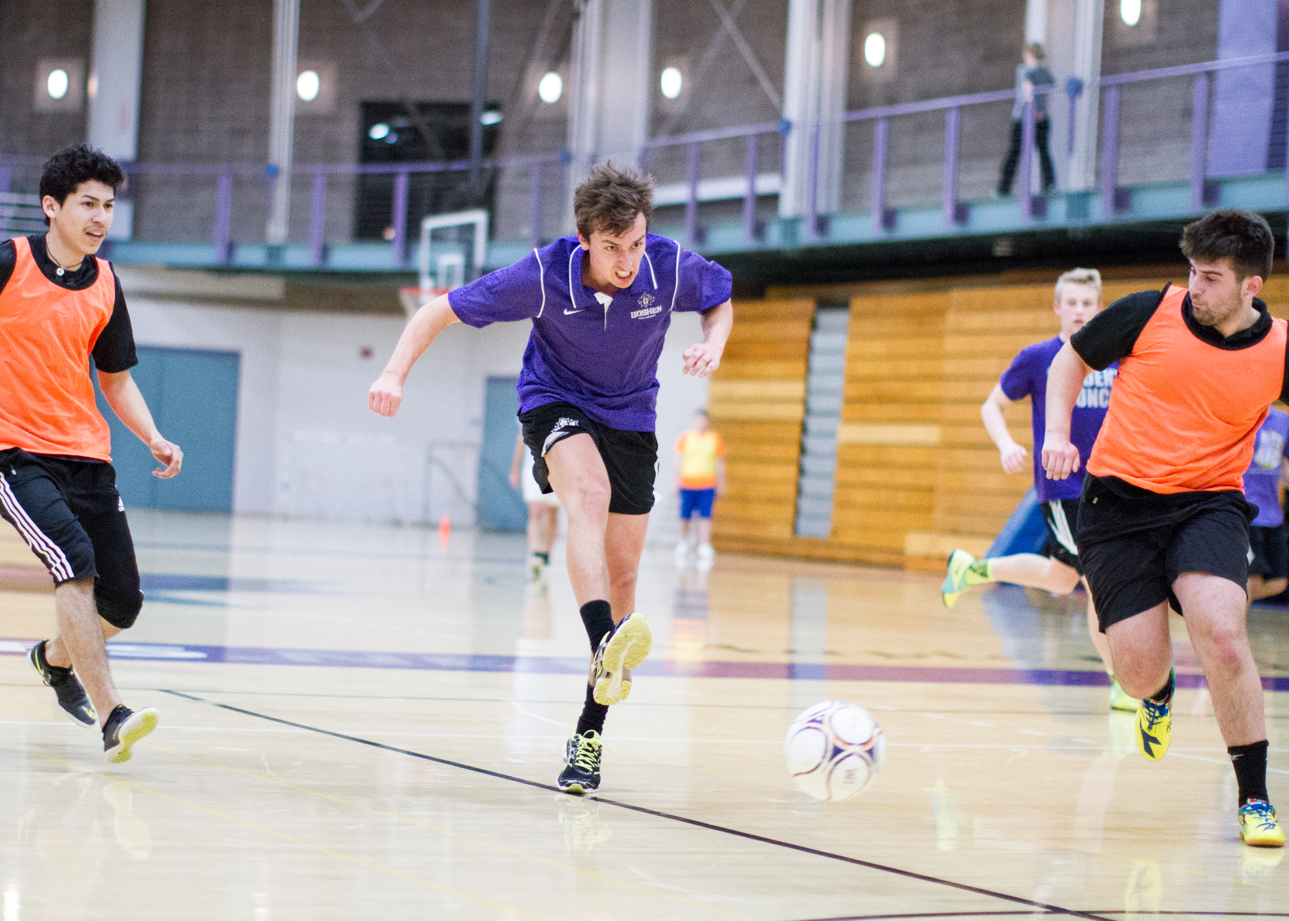 Three students play a game of intramural soccer in the RFC