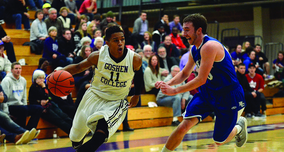 Stefon Luckey dribbles around an opposing player during a game. The bleachers in the background are full of spectators