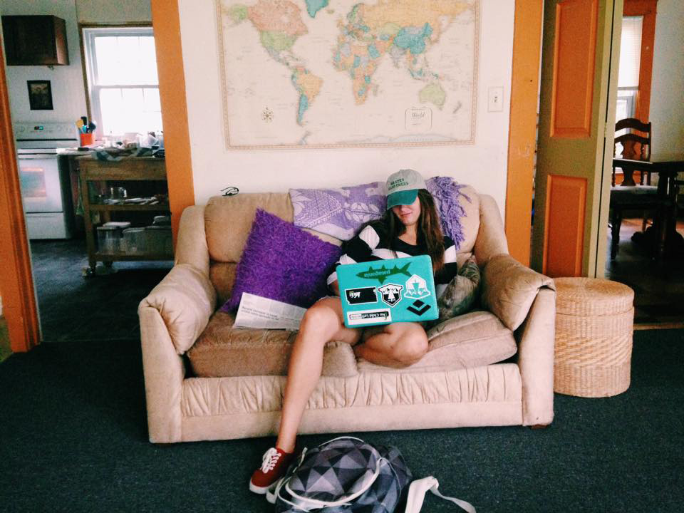 Grace Boehm works on her laptop on a couch in her house
