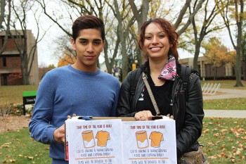 Latino Student Union leaders Jose Mendoza and Jessica Davila display the collection boxes for the LSU-sponsored Thanksgiving food drive. Photo by Dona Park.